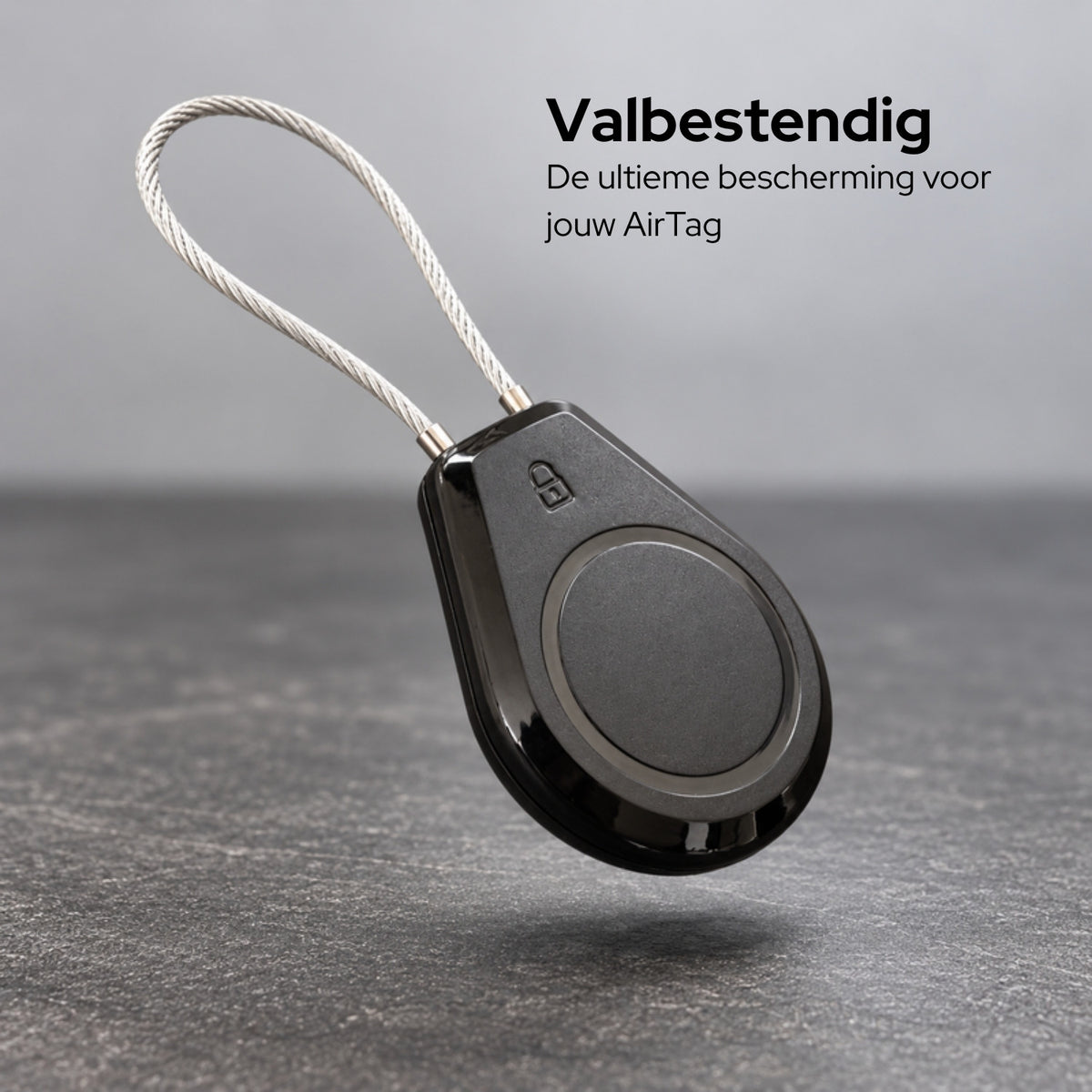 AirTag-houder met staaldraad boven een betonnen vloer